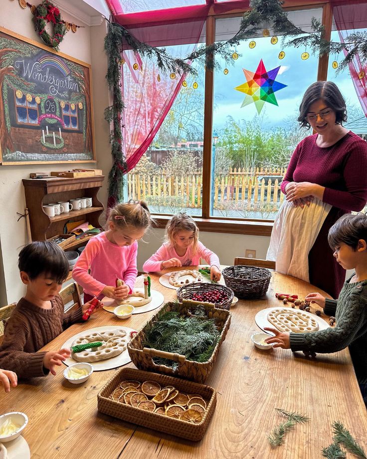 a group of children sitting around a table eating food