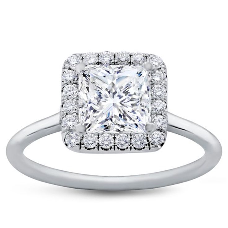 a princess cut diamond ring with pave set diamonds on the shoulders and sides, in white gold