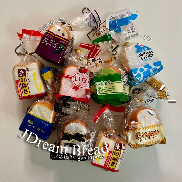 a pile of assorted candy bags sitting on top of a white table next to each other