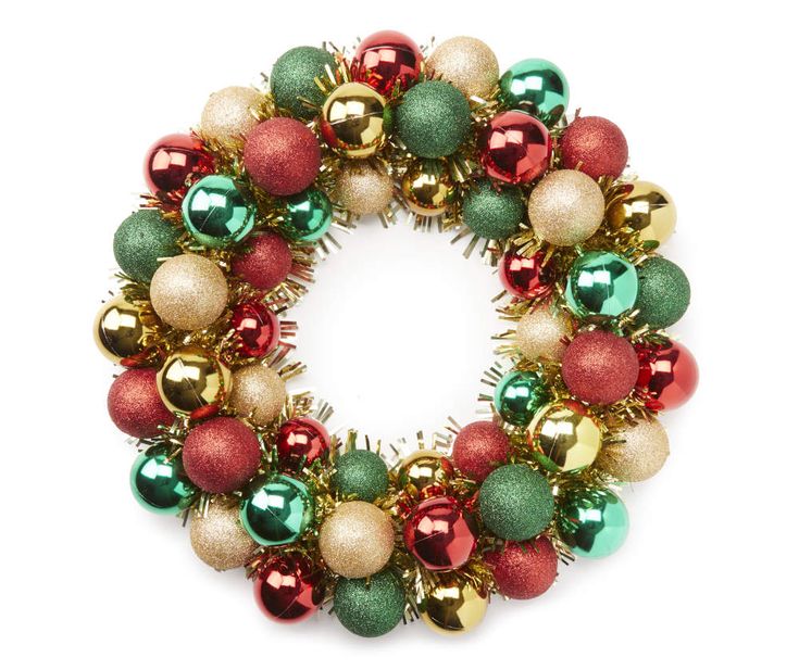 a christmas wreath with ornaments hanging from it's sides on a white background photo