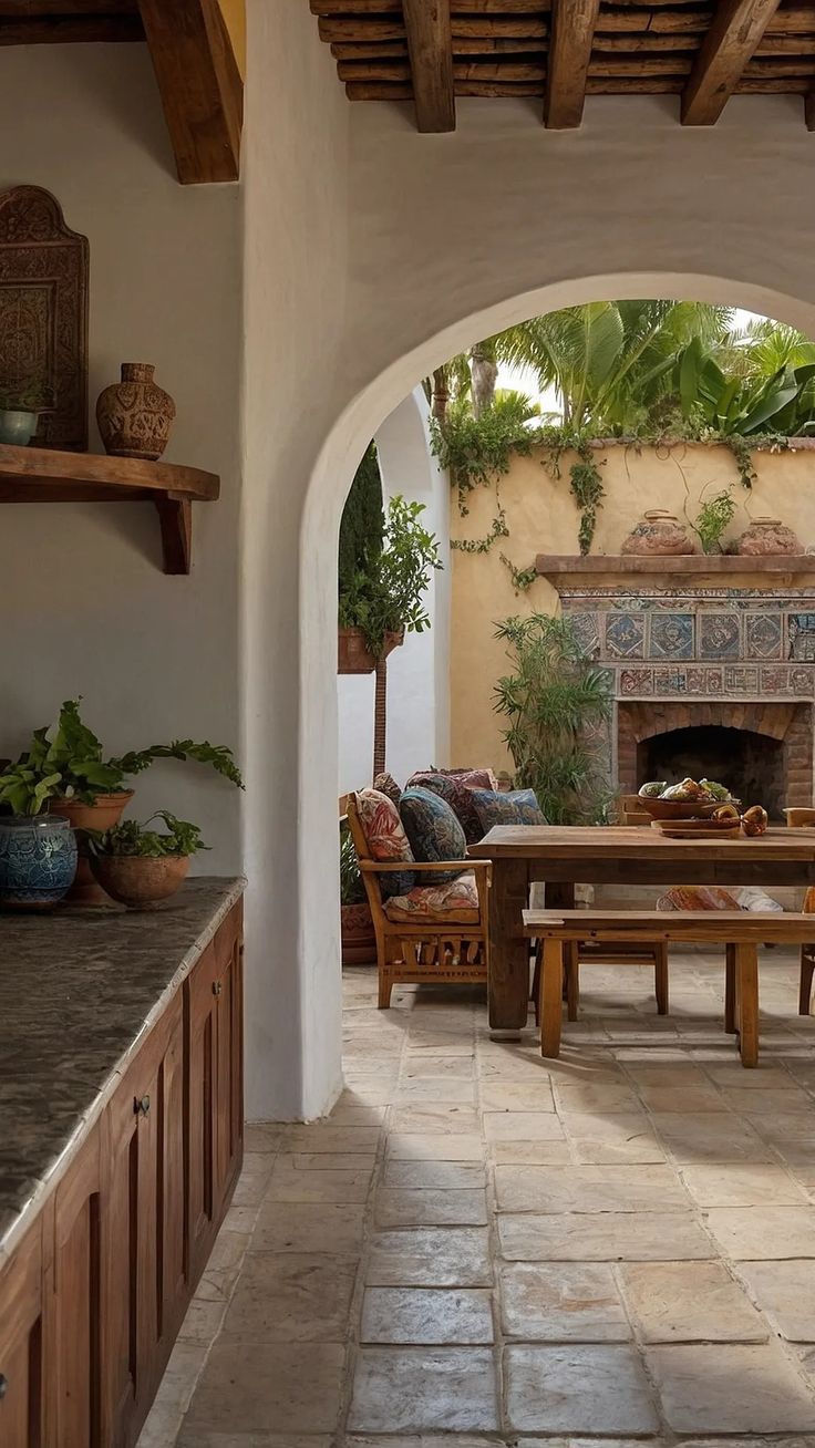 an outdoor living area with wood furniture and stone flooring