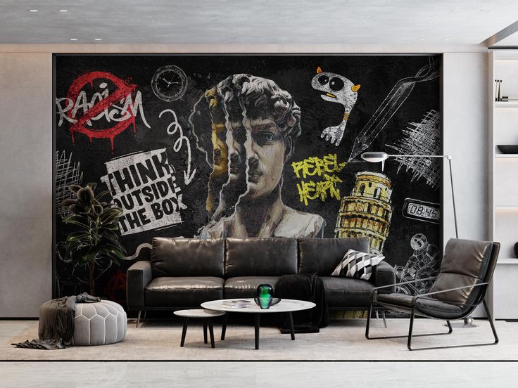 a living room filled with black furniture and graffiti on the wall behind it's couch