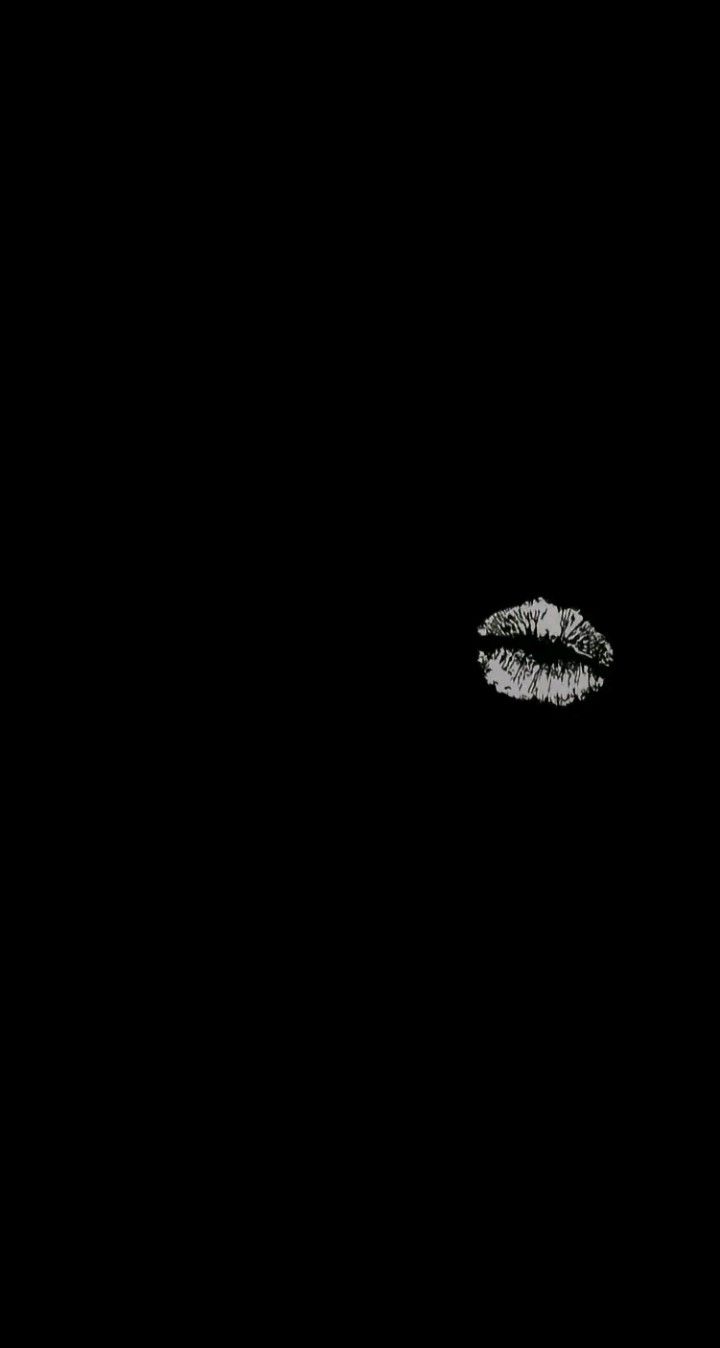 a black and white photo of two lips in the dark with some sparkles on them