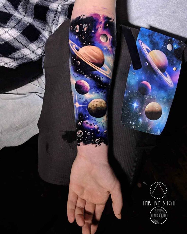 a person with a tattoo on their arm that has planets and stars all over it