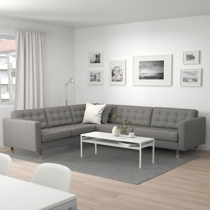 a living room filled with furniture and white walls