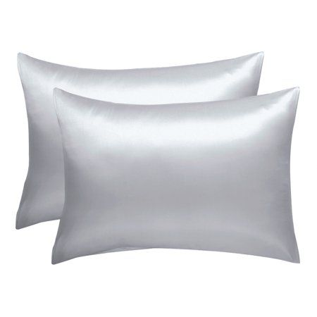 two silver pillow cases with satin pillows on the bottom and one white pillow case in the middle