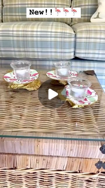 a wicker coffee table with two cups and saucers sitting on top of it