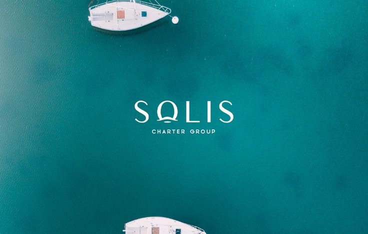 two small boats floating on top of a body of water with the words sails written above them