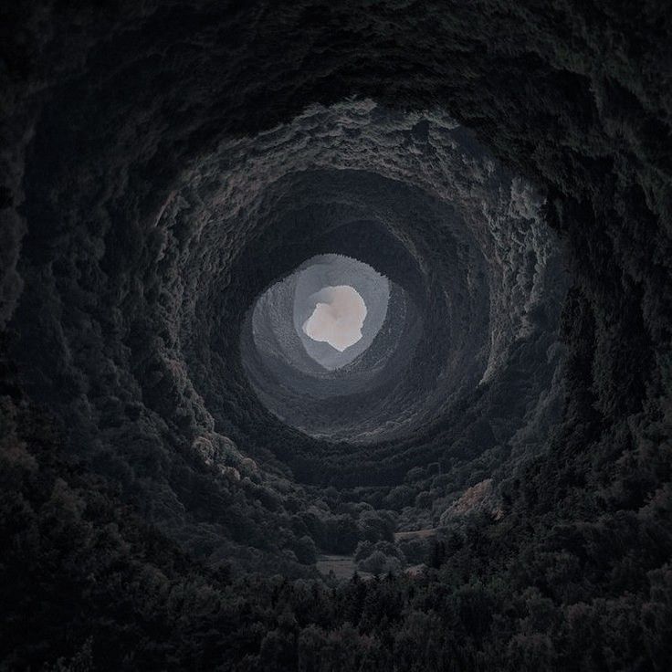 the inside of a cave looking up at the sky