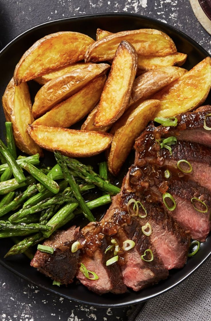 a plate with steak, potatoes and green beans