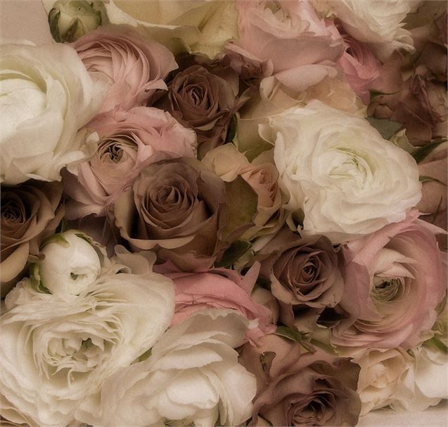 a bunch of flowers that are in the middle of some kind of flower arrangement on a table