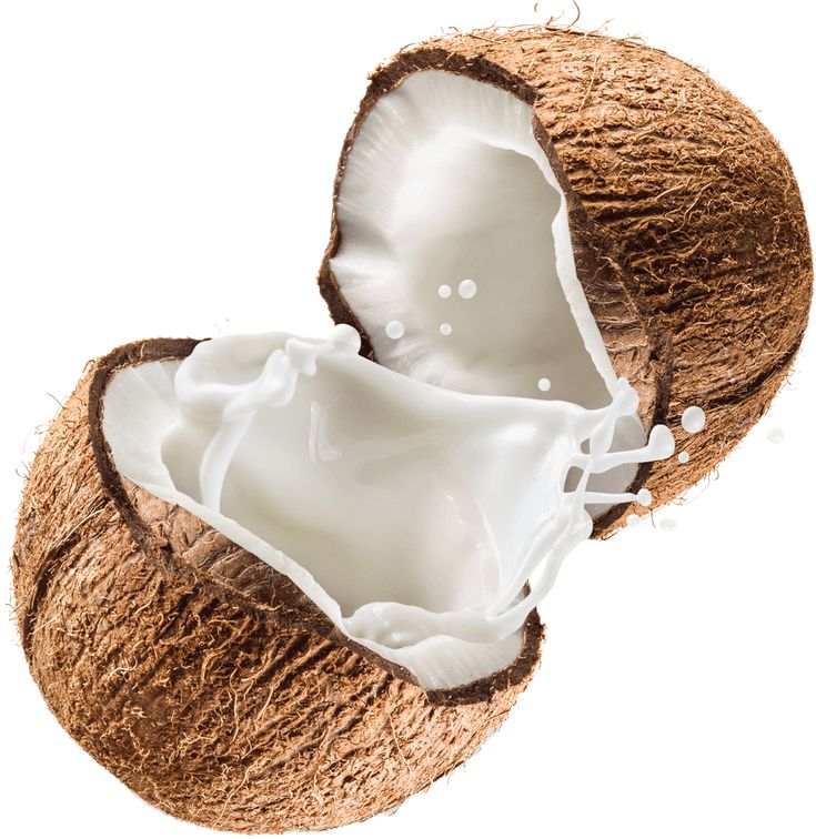 two halves of coconuts with milk in them