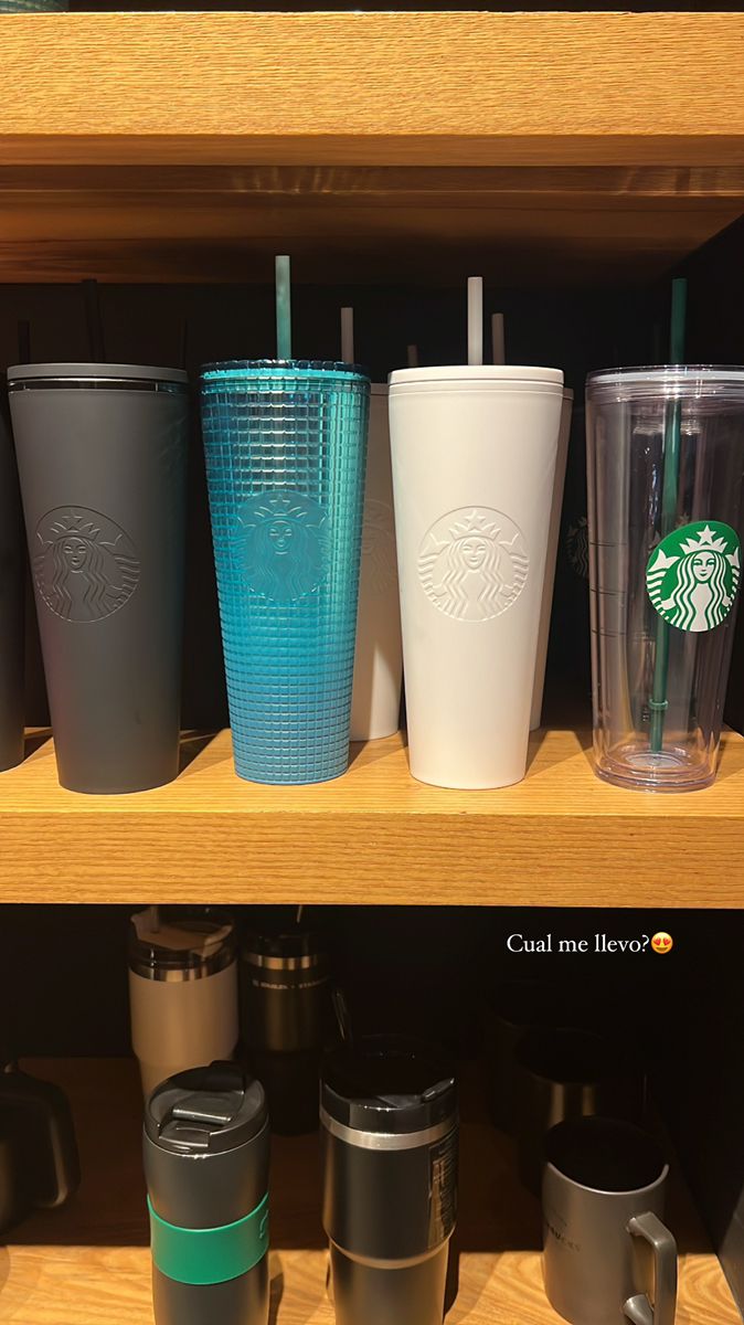 starbucks cups are lined up on the shelf