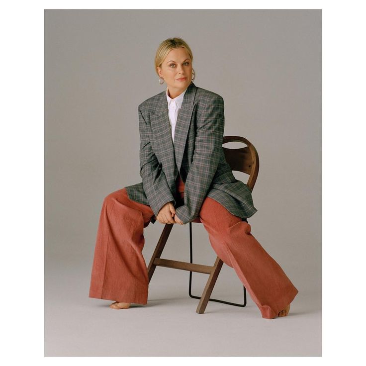 a woman sitting on top of a wooden chair