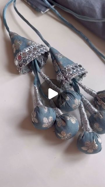 a video demonstrating how to make an ornament necklace with beads and fabric ribbon