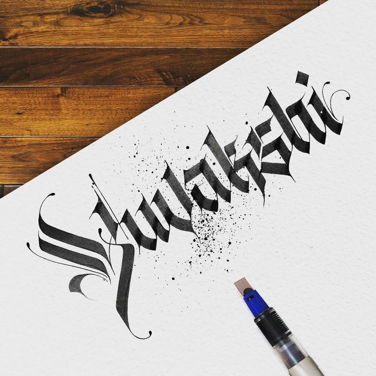 the word sulferia written in cursive writing on paper next to a paintbrush