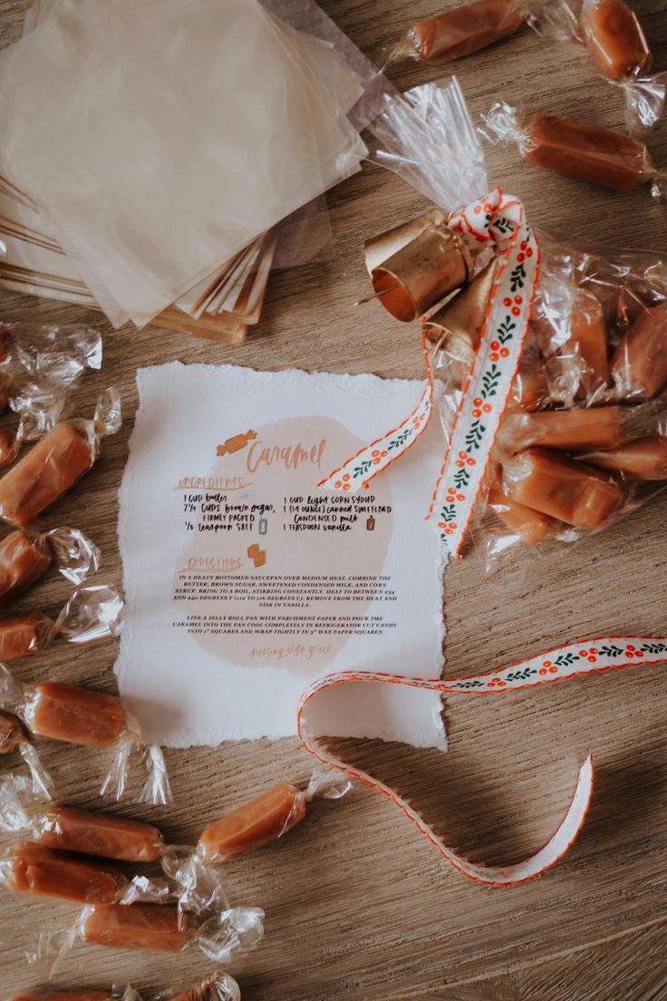 some candies are wrapped in plastic bags and tied up on top of a table