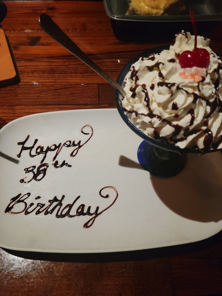 a birthday cake with whipped cream and a cherry on top is served in a bowl