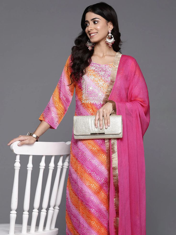 Grab this beautiful 3-piece set. The set comes with foil print, bandhani & zari embroidery kurta has round neck, 3/4th sleeves & calf length teamed with solid trouser pant with elasticated waistband and a slip-on closure and a silk chiffon dupatta with lace detailing. Color - Pink Kurta Fabric-Cotton Blend Bottom Fabric-Cotton Blend Dupatta Fabric - Silk Chiffon Neck-Round Neck Sleeves-3/4th Sleeves Work - Foil Print, Bandhani & Zari Embroidery Washing Instructions-Hand Wash DISCLAIMER - The col Designer Georgette Palazzo Set With Bandhani Print, Semi-stitched Bandhani Print Salwar Kameez, Eid Bandhani Print Palazzo Set For Designer Wear, Eid Designer Palazzo Set With Bandhani Print, Diwali Multicolor Anarkali Set With Straight Kurta, Eid Bandhani Print Georgette Palazzo Set, Designer Pink Palazzo Set With Bandhani Print, Designer Wear Pink Palazzo Set With Bandhani Print, Multicolor Straight Kurta With Dupatta Palazzo Set