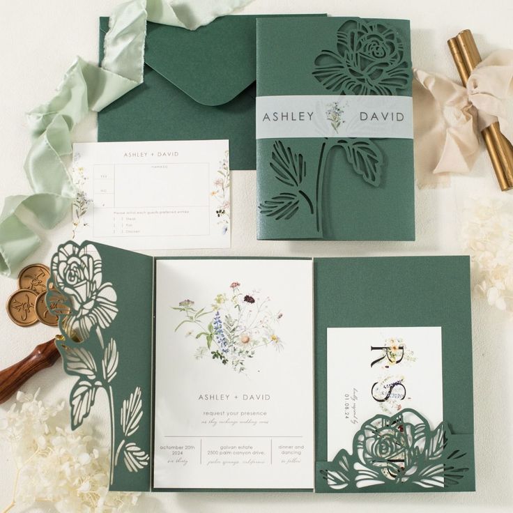 the wedding stationery is green and white, with flowers on it's side