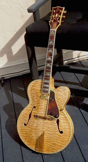 a guitar sitting on top of a wooden floor