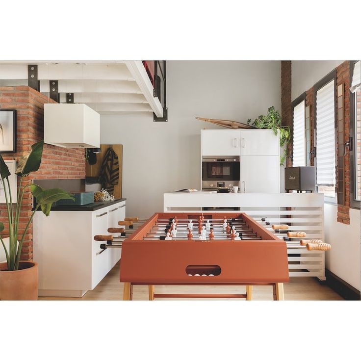 a foosball table in the middle of a kitchen