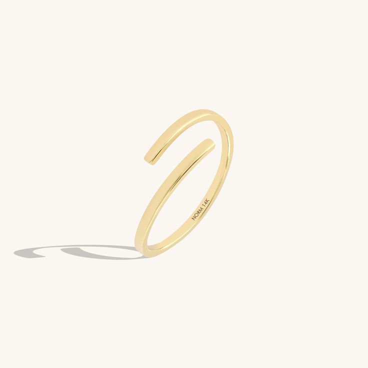 Introducing our Minimalist Bypass Ring, a sleek and understated addition to your jewelry collection. This ring features a plain design that embodies minimalist elegance. Its bypass style allows for effortless stacking with other rings, offering versatility and customization to your look. Elevate your style with this timeless and versatile accessory that exudes simplicity and sophistication. - Made in 14k solid gold - Band Width: 1.42 mm / 0.05 inches - Thickness: 1.06 mm / 0.04 inches -This prod Solid Gold Band, Bypass Ring, Plain Design, Gold Band, Stackable Rings, Signet Ring, Solitaire Ring, Ring Bracelet, Rings Statement