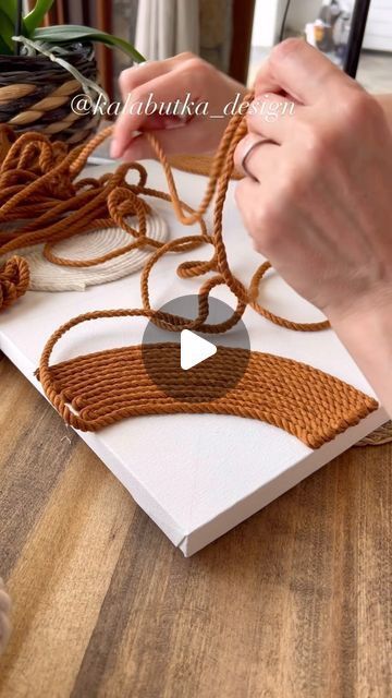 a person is making something with yarn on the table and it looks like an ornament