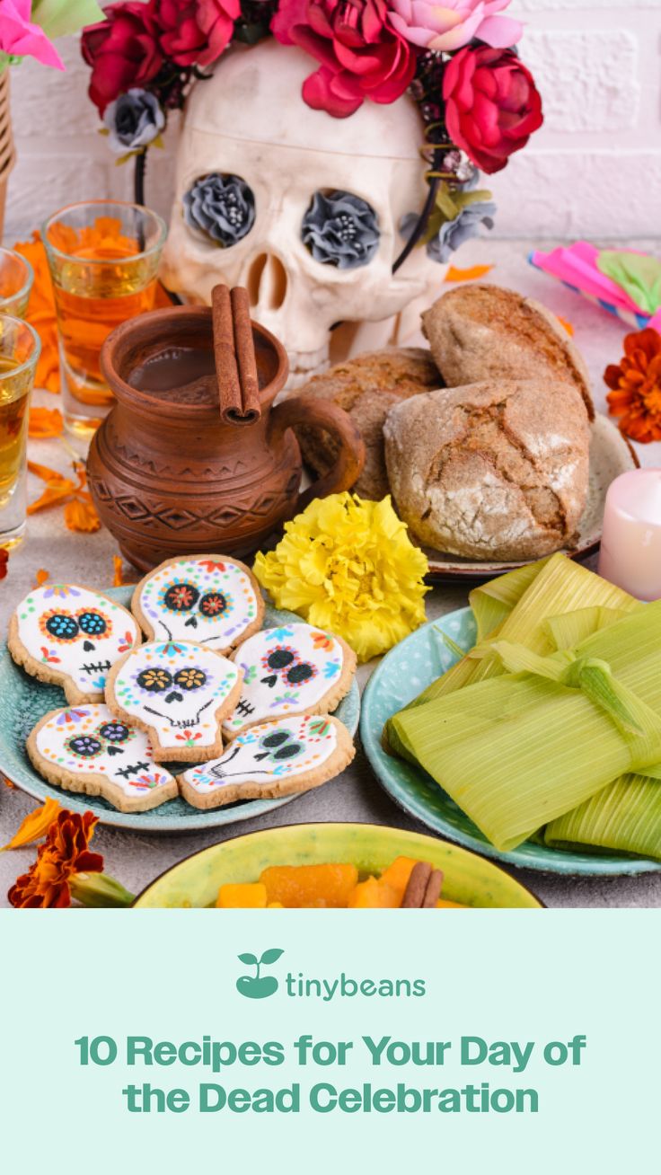 a table topped with lots of food next to a skull