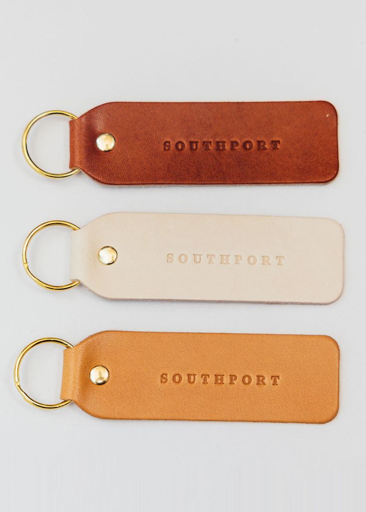 three leather key fobrings with the word southport on one side and two other