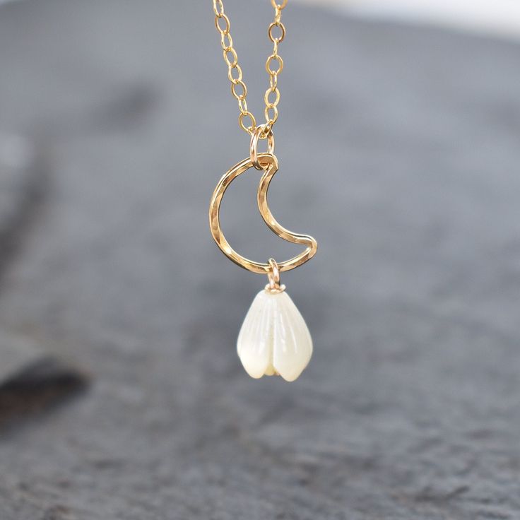 Cute and dainty crescent moon accented with a small 8mm white mother of pearl Pikake bead. Made from your choice of gold fill or sterling silver. This material will NOT tarnish and can even get wet! Please be sure of your necklace length before ordering. Each necklace is made to order, resizing is subjected to fees. White Dainty Jewelry With Moon Charm, White Half Moon Jewelry For Gift, Dainty White Moon Phase Jewelry, White Moon Shaped Necklace For Gift, Moon Shaped White Necklace For Gift, White Jewelry With Moon Charm For Wedding, White Moon Phase Necklace For Wedding, Dainty White Crescent Necklace, White Crescent Bohemian Jewelry