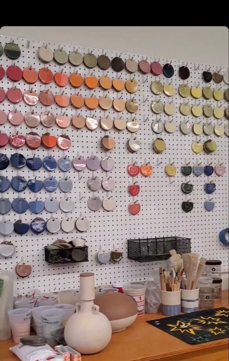 there is a wall covered with lots of magnets and paintbrushes on it