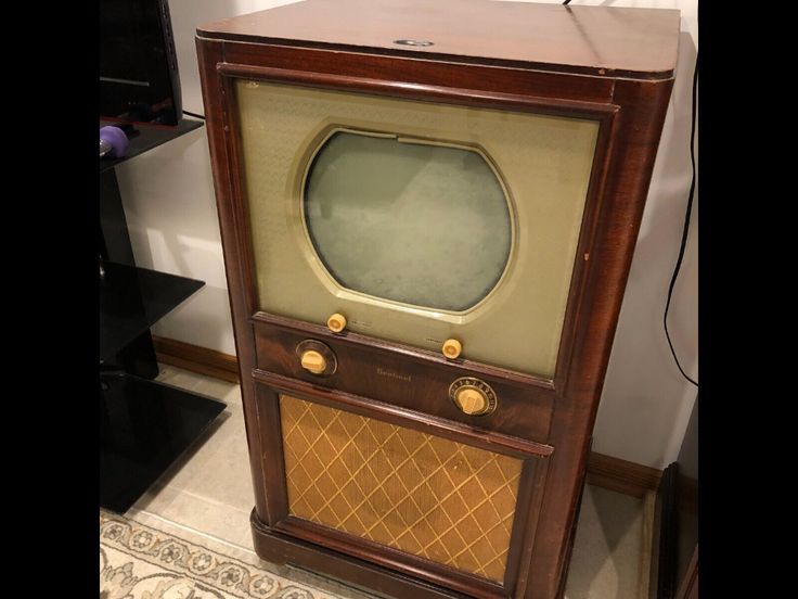 an old fashioned tv sitting on top of a table