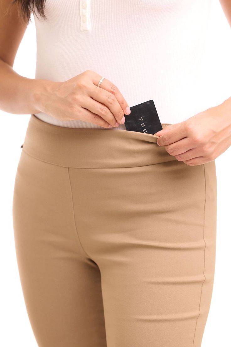 You deserve something more than boring office pants. These straight leg capris can take care of both your look and comfort. The stretchable fabric allows an unbelievable 360-degree range of movement, which means you’re ready for everything from business acrobatics to group aerobics. The hidden pocket built right into the waistband of these capris can be your secret to change your look in minutes by tucking away your cute earrings. Pull-on style with light tummy control panel Secret pocket hidden Fitted Capri Length Pants For Work, Fitted Capri Length Work Pants, Stretch High-waisted Leggings For Office, Fitted Workwear Capri Pants, Stretch Dress Pants With Elastic Waistband For Business Casual, Stretch Business Casual Dress Pants With Elastic Waistband, Elegant Stretch Capris, Elastic Waistband Knee-length Pants For Work, Knee-length Pants With Elastic Waistband For Work