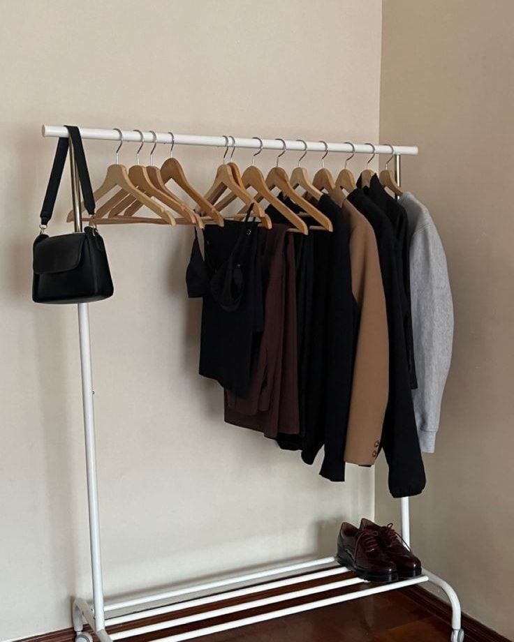 there is a rack with clothes and shoes on it