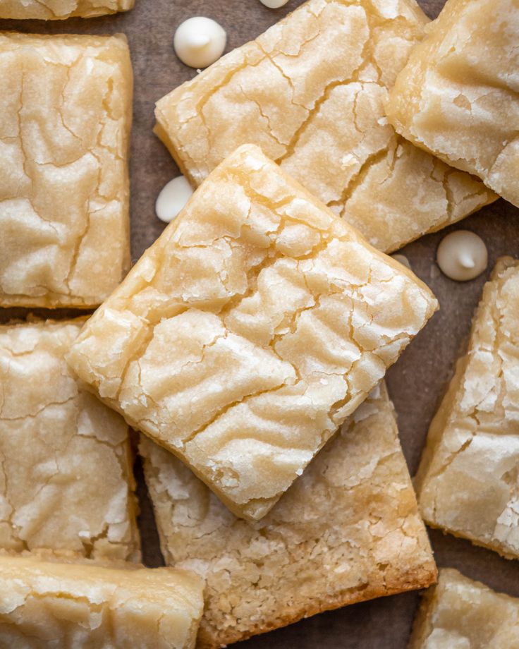 several pieces of white cake sitting on top of a table