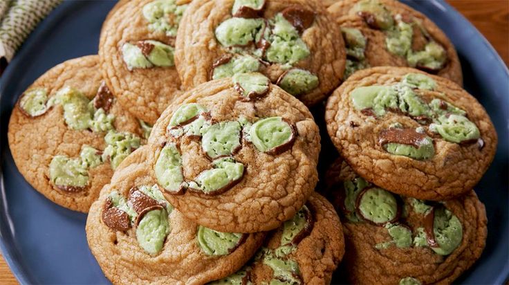 chocolate chip cookies with green frosting on a blue plate