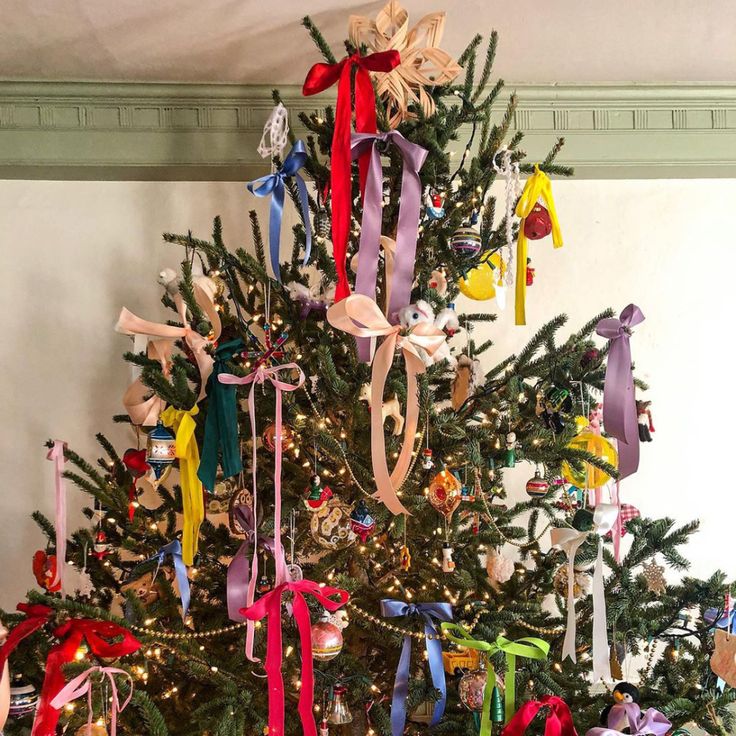 a decorated christmas tree with ribbons on it