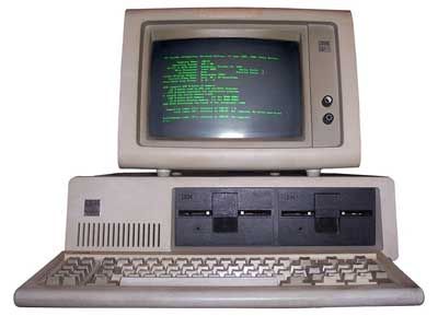 an old computer sitting on top of a white desk next to a keyboard and mouse