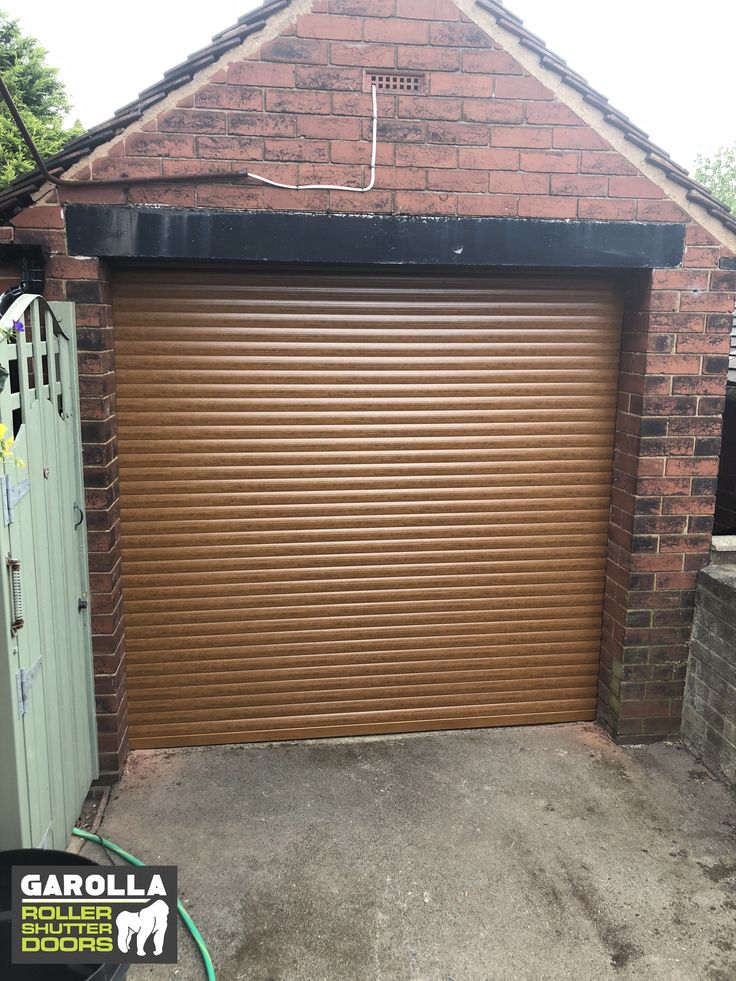 a brown garage door is open in front of a brick building