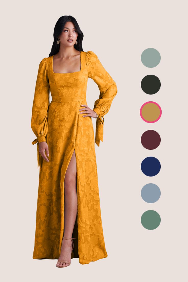 a woman wearing a yellow dress with long sleeves and a slited leg, standing in front of color swatches