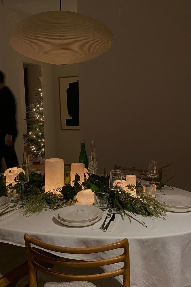 the table is set with candles and plates