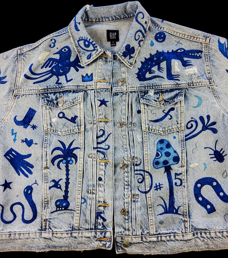 a jean jacket with blue and white designs on it