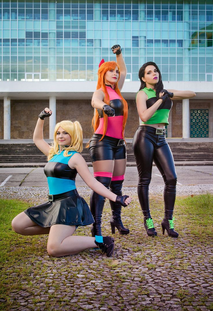 three women dressed in costumes posing for the camera