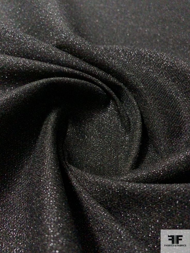 the fabric is black and shiny with some silver flecks on it's surface