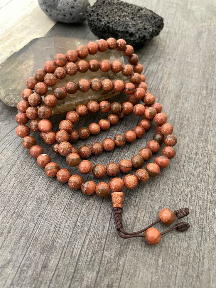 Unique and powerful Goldstone Japa mala Necklace from Nepal. A unisex piece that will be perfect for your day by day outfits and will be easy to match any other accessories. If it fits right can be a bracelet also. This is also a Buddhist praying 108 beads mala. The japa mala is 42.5cm- 16.75 inch long A unique addition to your jewelry collection. Enjoy Con salud Buddhist Mala, Yoga Necklace, Mala Bead Necklace, Beads Mala, 108 Mala Beads, 108 Bead, Mala Necklace, Mala Beads, Prayer Beads