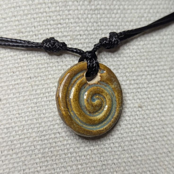 Handmade Light Brown Ceramic Coin Spiral Pendant Y2k Style Boho Hippie Whimsical Choker Adjustable Black Corded Necklace Clay Charms Jewelry. These Are Made By Hand, Glazed And Kiln Fired. Color And Design May Vary Slightly As These Are Handmade. Comes On An Adjustable Waxed Black Cord Necklace. Necklace Is Adjustable From Approximately 14" To 28". To Wear Your Necklace Pull The Two Knots Away From The Pendant To Adjust To A Larger Size, Leave About An Inch Of Space Between The Two Knots To Prev Silver Clay Pendant, Pjo Dr, Necklace Clay, Green Clothes, Corded Necklace, Accessory Inspo, Spiral Pendant, Polymer Clay Flower Jewelry, Black Cord Necklace