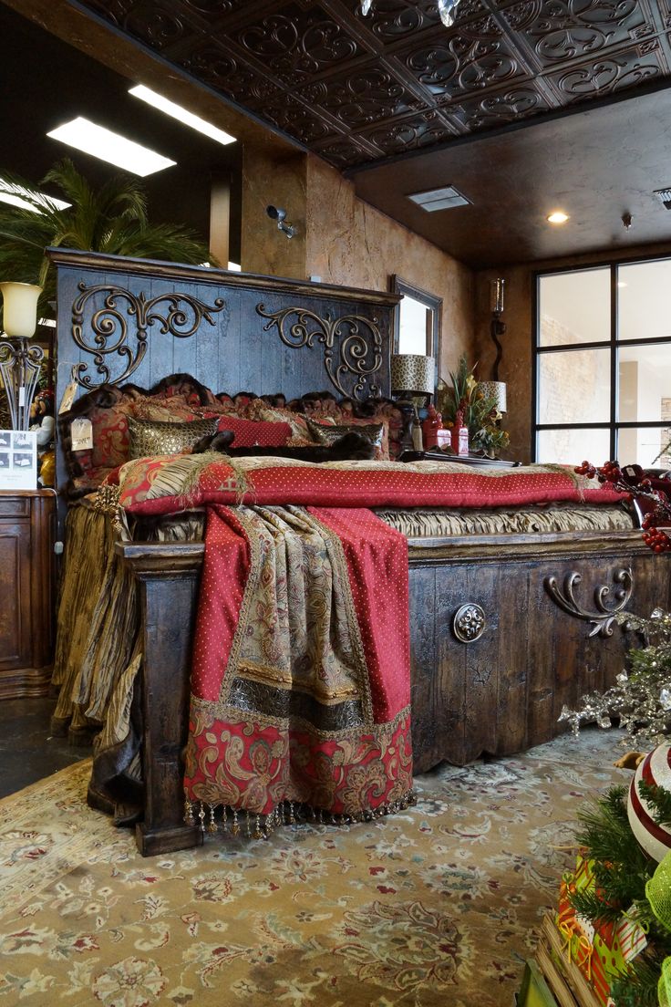 a large bed sitting inside of a bedroom on top of a carpeted floor next to a window