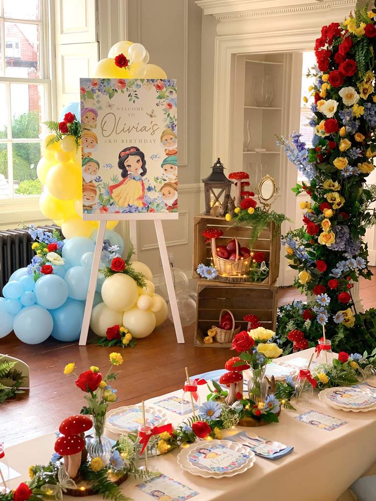 a table set up for a snow white birthday party