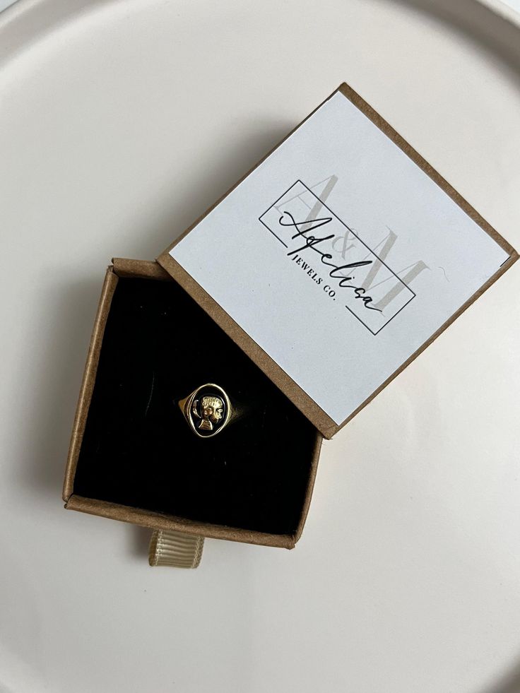 the main material of this ring is gold plated brass. It is an adjustable model and suitable for all sizes. The ring is sent in the box shown in the image. Antique Open Ring Jewelry For Gift, 14k Gold Tarnish-resistant Crystal Ring As Gift, Gold Brass Rings As Gifts, Tarnish Resistant 14k Gold Crystal Ring As Gift, Tarnish-resistant 14k Gold Crystal Ring For Gifting, Classic Crystal Ring As Gift, Vintage Yellow Gold Midi Rings For Wedding, Classic Brass Dome Ring As Gift, Classic Brass Dome Ring Gift